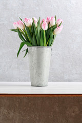 Pink tulips in silver bucket.