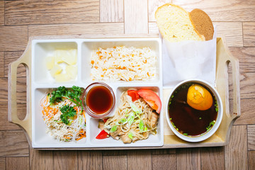Plate with a set of food on a tray on the table.