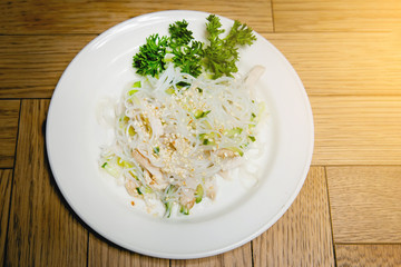 Plate with food on a wooden table.