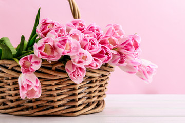 Huge bouquet of pink tulips in wicker basket