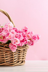 Huge bouquet of pink tulips in wicker basket