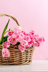 Huge bouquet of pink tulips in wicker basket