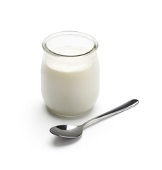 Glass jar yogurt with spoon isolated on white background