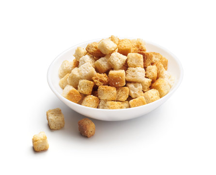 Crispy croutons in bowl isolated on white background