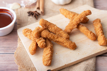 Hot and spicy Korean barbeque fried chicken on wood cutting board