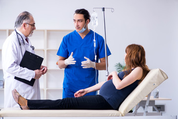 Fototapeta premium Two doctors examining young woman