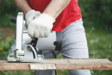Carpenter with electric disc saw.