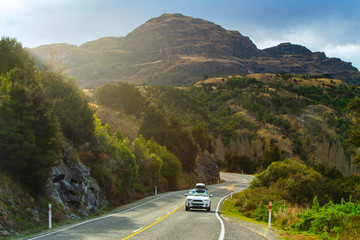 Mountain road and car with beautiful afternoon light in Wanaka, New Zealand