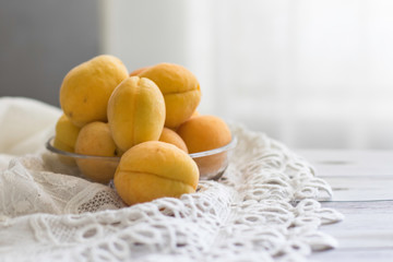 fresh apricots on a gray background with a light textile with copyspace