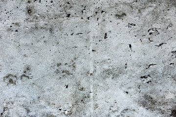 Texture of a concrete wall with cracks and scratches which can be used as a background