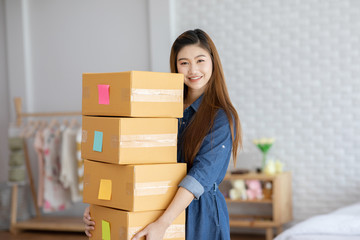  SME entrepreneur Young Asian women lifting packaging order for Online shopping at home,Cheerful and Happy with box for packaging in home,Own Business Start up for Business Online and Online shopping