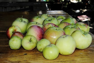 apples and pears on wooden table
