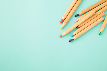 Obraz premium Colorful pencils on pastel pale blue