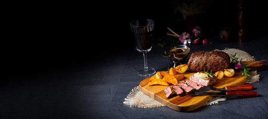 rustic medium butter beef steak with herbs and potato wedges