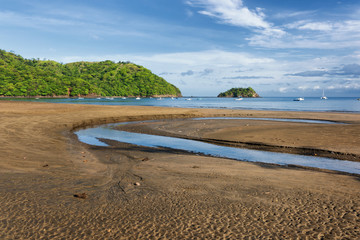 View of a volcanic beach on the pacific coast of central America. Playa del Coco, Guanacaste, Costa Rica.