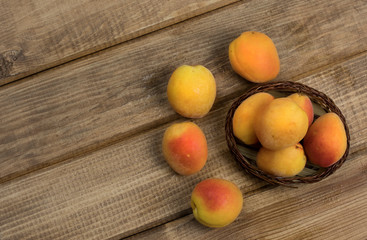 Apricot berries on wood background.