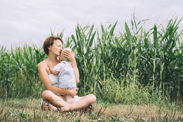 Mother and baby outdoors. Family on nature.