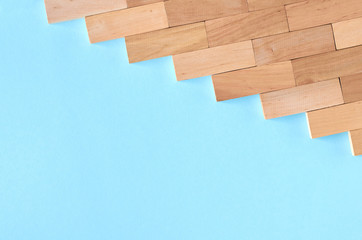 Brown wooden blocks idea on blue background composition.