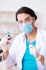 Fototapeta premium Young male chemist working in the lab