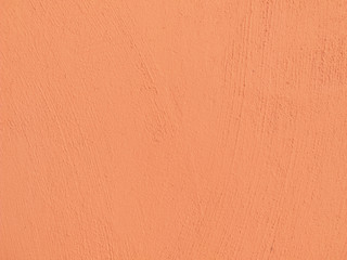 Textured plaster in coral . Background or texture seamless pattern