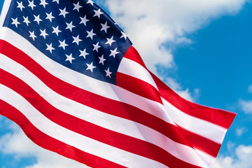 American flag waving in the wind against blue sky