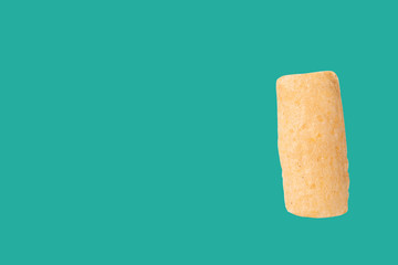 Rod Snack tube isolated on green background with space for copy.