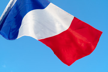 Flag of France waving in the wind in the sky