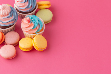 Tasty cupcakes sweets on pink background close up