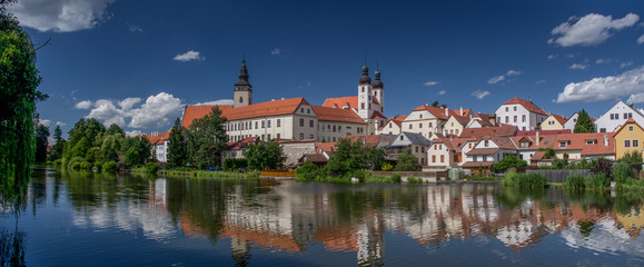 UNESCO protected Czech city Telc city scape on the castle with water reflection