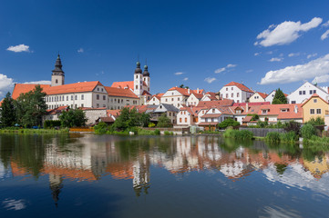 UNESCO protected Czech city Telc city scape on the castle with water reflection