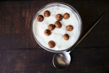 Top view yogurt and hazelnuts breakfast