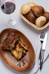 fried beef stake with potatoes and sprouted peas on a white table