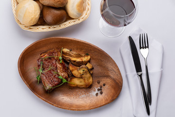 fried beef stake with potatoes and sprouted peas on a white table