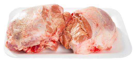 Close up of raw pig's cheeks on white table, nobody