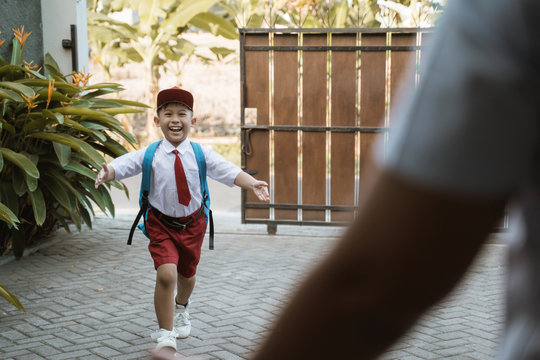 boy with school uniform getting excited when coming back home after school
