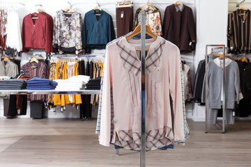 Modern clothes on hangers and shelfs