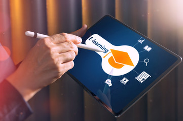 The woman selects graduation hat icon on her tablet pc. Concept of e-learning, online course,...