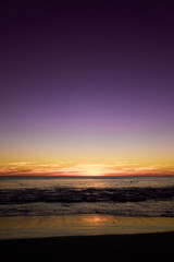 Portrait Sunset taken from a beach on Perth Western Australia.  Deep blue, florescent oranges and reds 