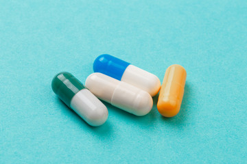 colour tablets and pills on blue background .