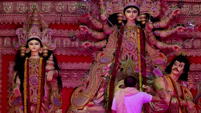 A man worshiping goddess durga with a pure holy flame in his hands - Navratri. 
