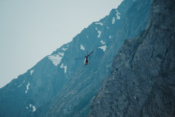 Helicopter flying besides mountains in Badrinath, Uttarakhand, India