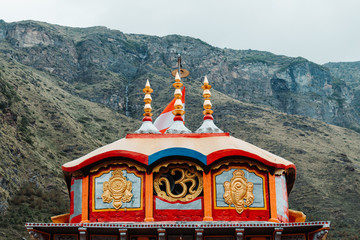 View of the top of the Badrinath temple with mountains behind it in Uttarakhand, India