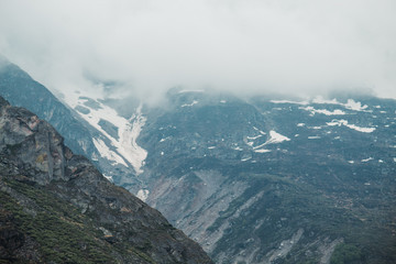 Snow covered mountains with clouds in Badrinath, Uttarakhand, India