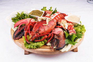 Mediterranean cuisine, lobster stuffed with cabbage, greens and sauces
