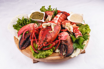 Mediterranean cuisine, lobster stuffed with cabbage, greens and sauces