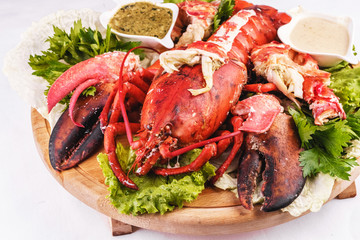 Mediterranean cuisine, lobster stuffed with cabbage, greens and sauces