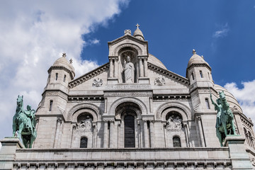 Fototapeta na wymiar Detail of Paris Basilica Sacre Coeur at the top of Montmartre - Roman Catholic Church and minor basilica, dedicated to Sacred Heart of Jesus. Paris, France.