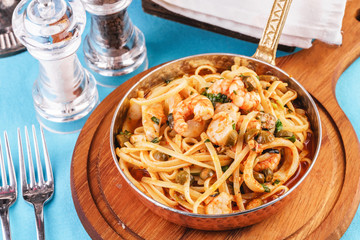 Mediterranean pasta with shrimps, onions, cucumbers and hot peppers