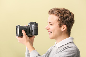 Fototapeta premium Teenage boy with photo camera at home