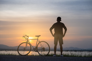 Fototapeta na wymiar Cyclist on background of sunset, sport and travel concept